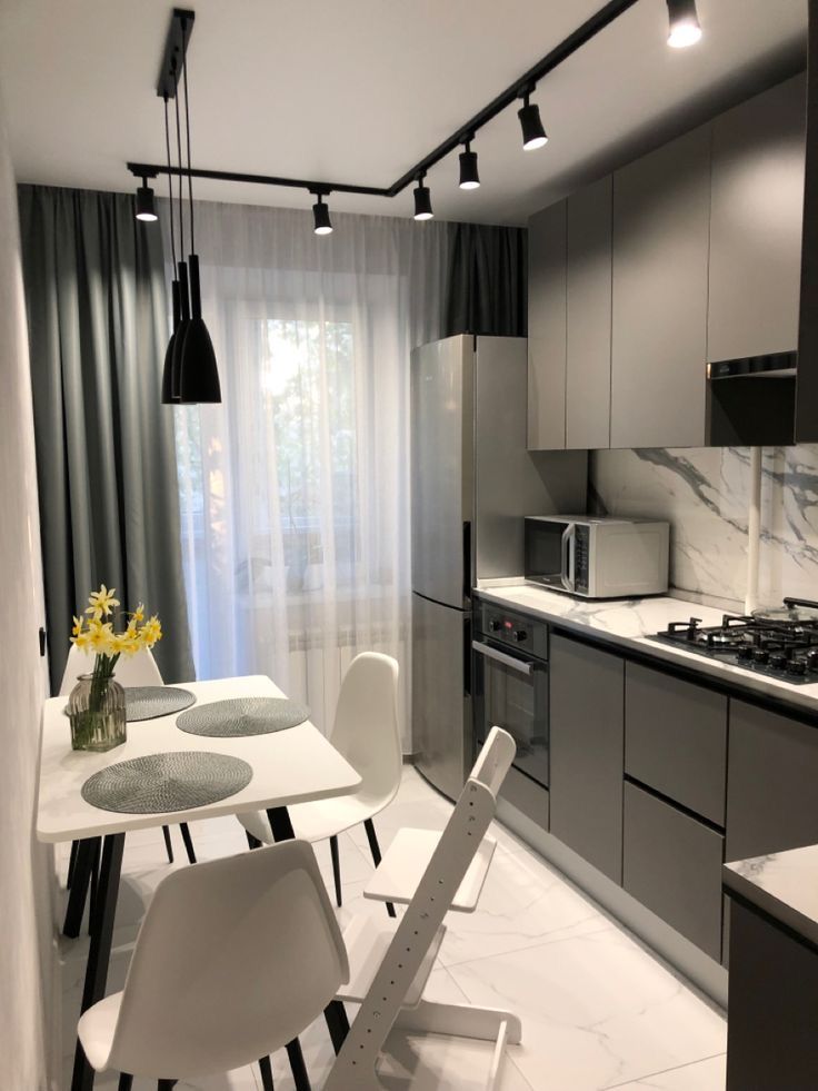 a white table and some chairs in a room