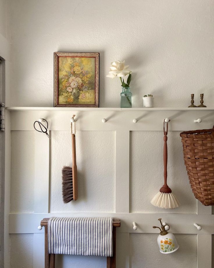 there are many items on the shelf above the towel rack