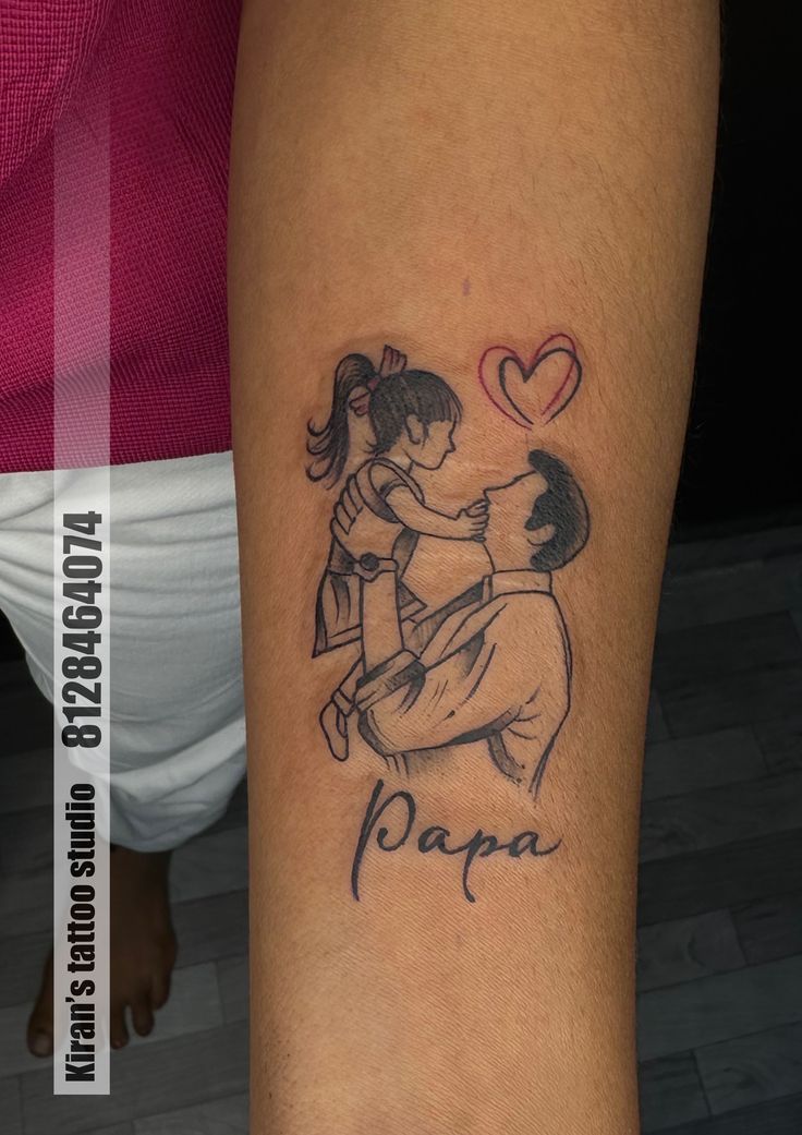 a couple hugging each other with the word papa tattooed on their arm