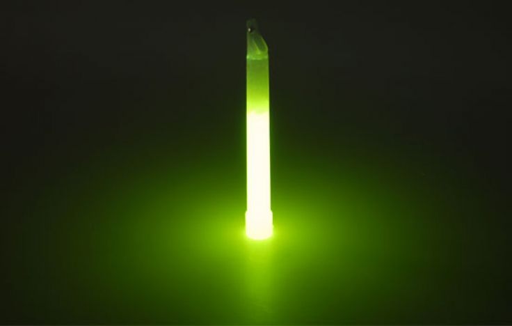 a green light shines in the dark, with a long tube sticking out of it