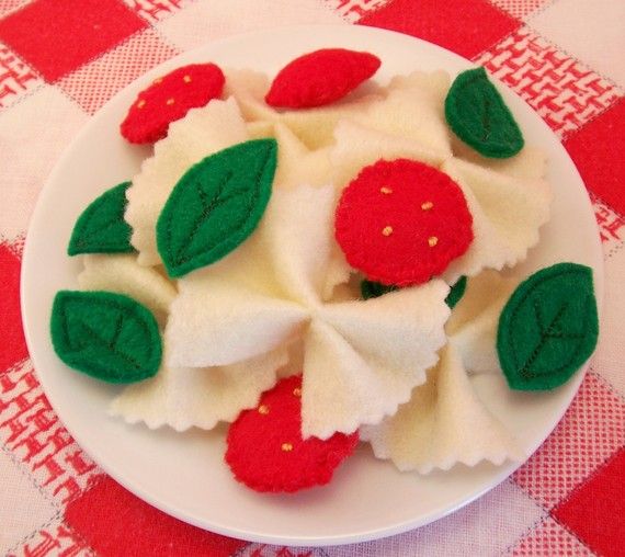 a white plate topped with fruit covered in icing on top of a red and white checkered table cloth