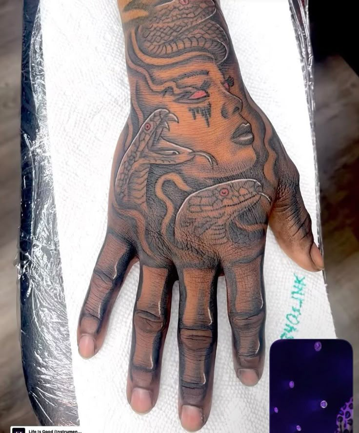 a person's hand with a tattoo on it