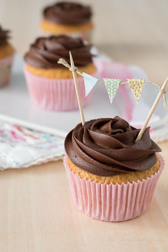 cupcakes with chocolate frosting and bunting flags