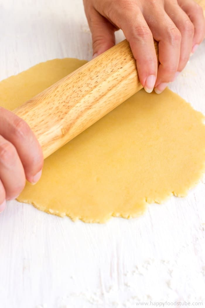 a person rolling dough on top of a table