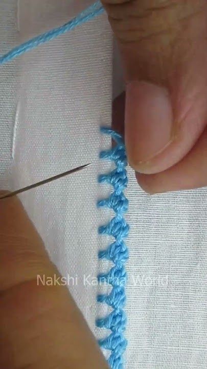 someone is cutting through the stitchs on a piece of fabric