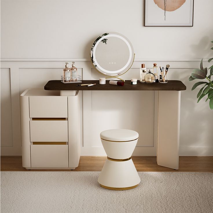 a white toilet sitting under a mirror next to a table