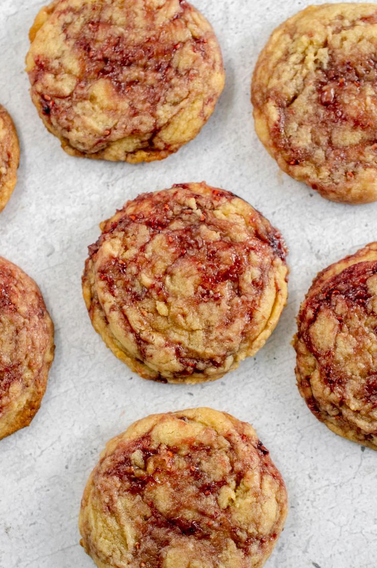 twelve cookies with crumbs sitting on a piece of paper