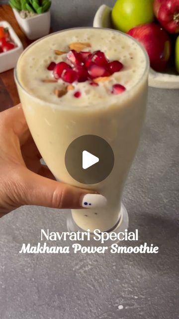 a person holding up a drink in front of some fruit on the table with text that reads, navrati special mahana power smoothie