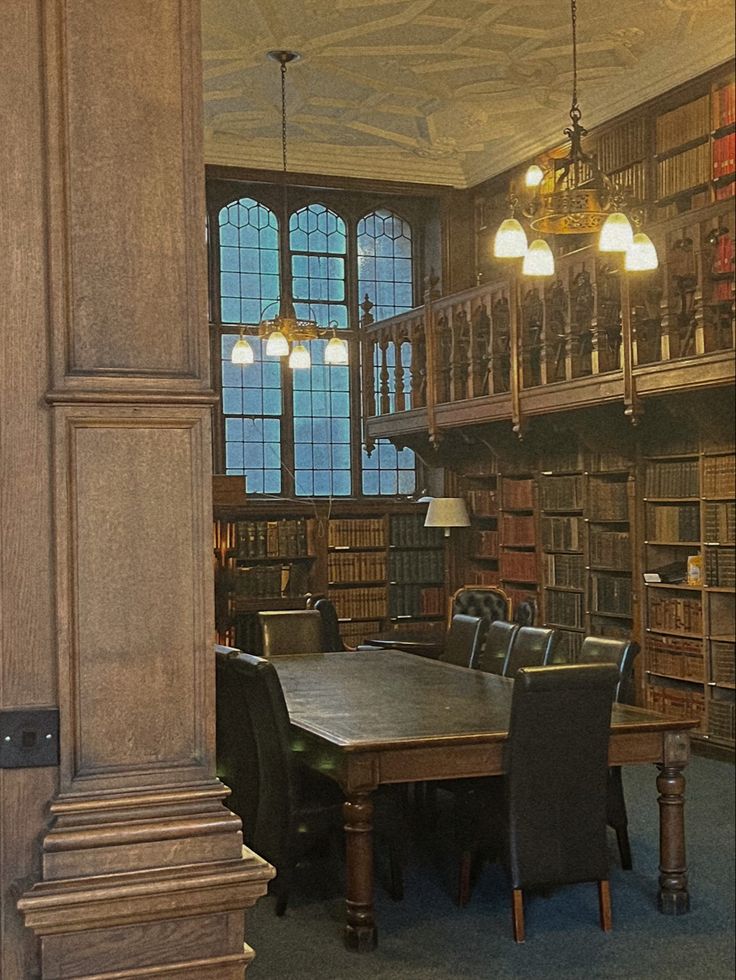 an old library with many bookshelves and tables in the center is lit by lamps