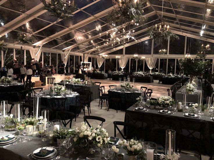 a banquet hall with tables and chairs set up for an event