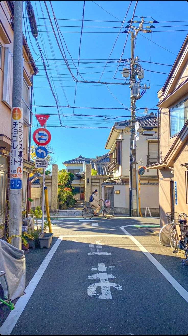 an empty street with many buildings and bicycles parked on the side walk in front of it