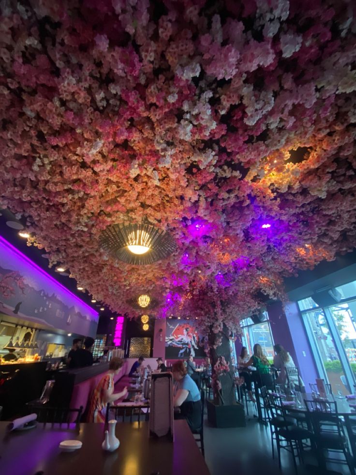 the ceiling is decorated with flowers and lights in an elegant restaurant or diners area