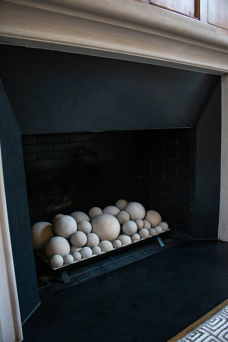 a fireplace with some white balls in it