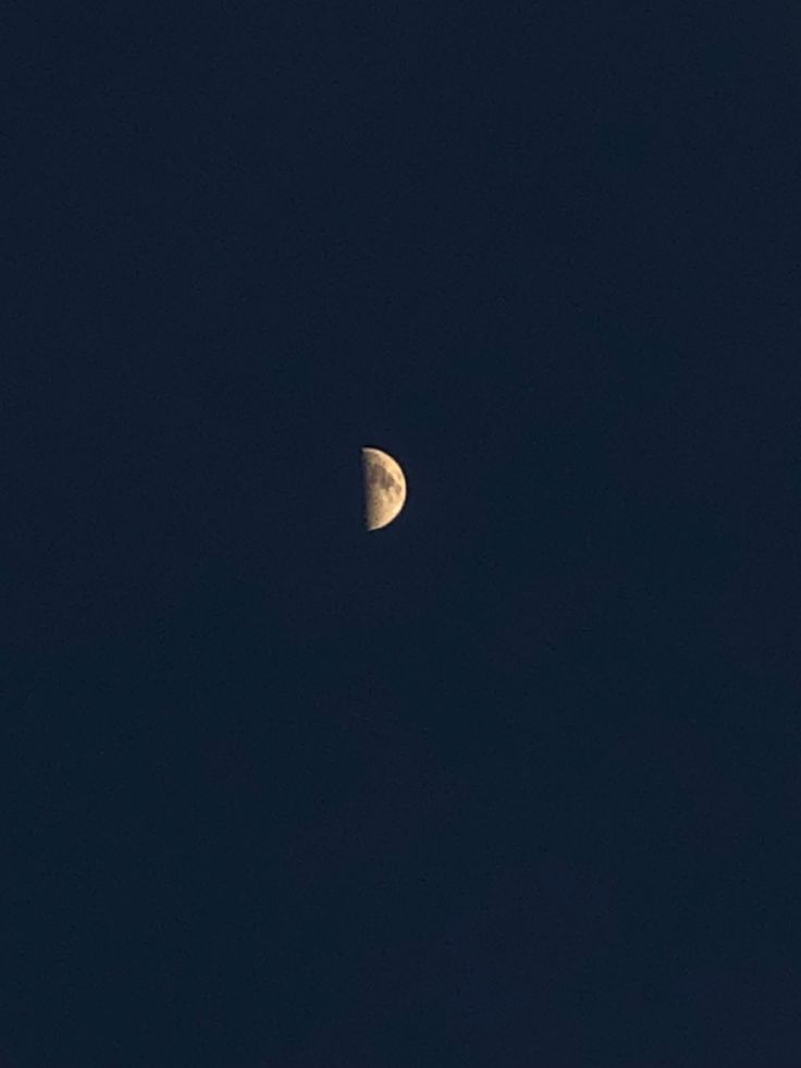 the moon is seen in the dark sky with no clouds on it's side