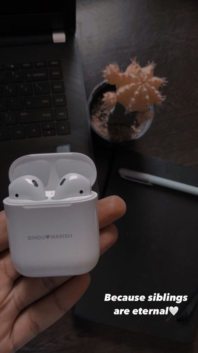 someone is holding an airpods in their hand