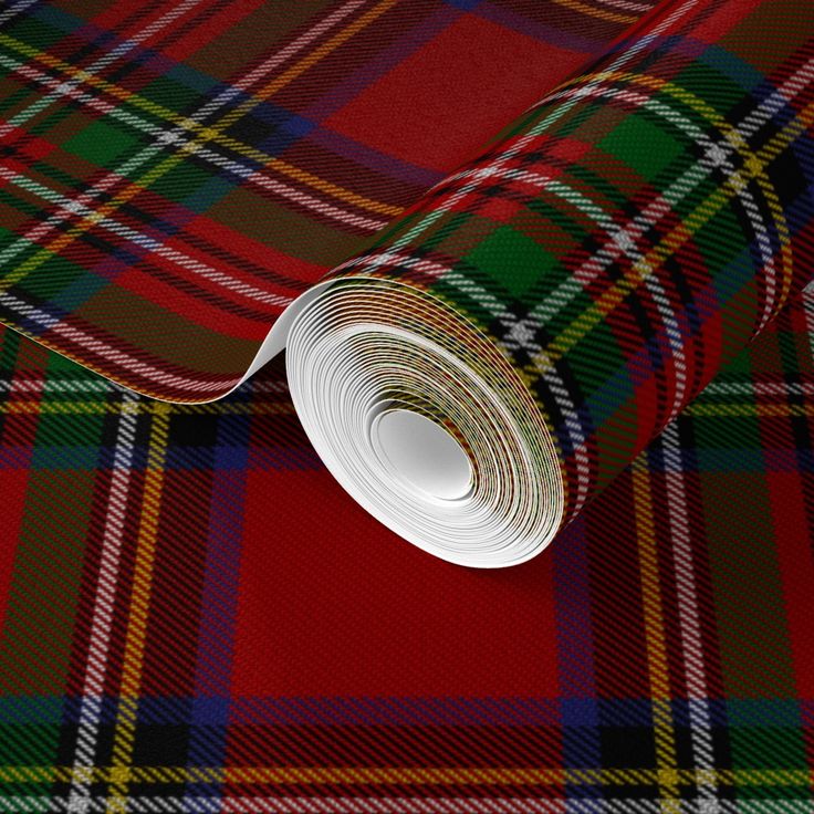 a red and green tartan plaid fabric with a roll of tape on the side