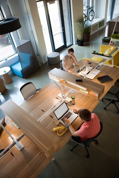 two people sitting at desks in an office