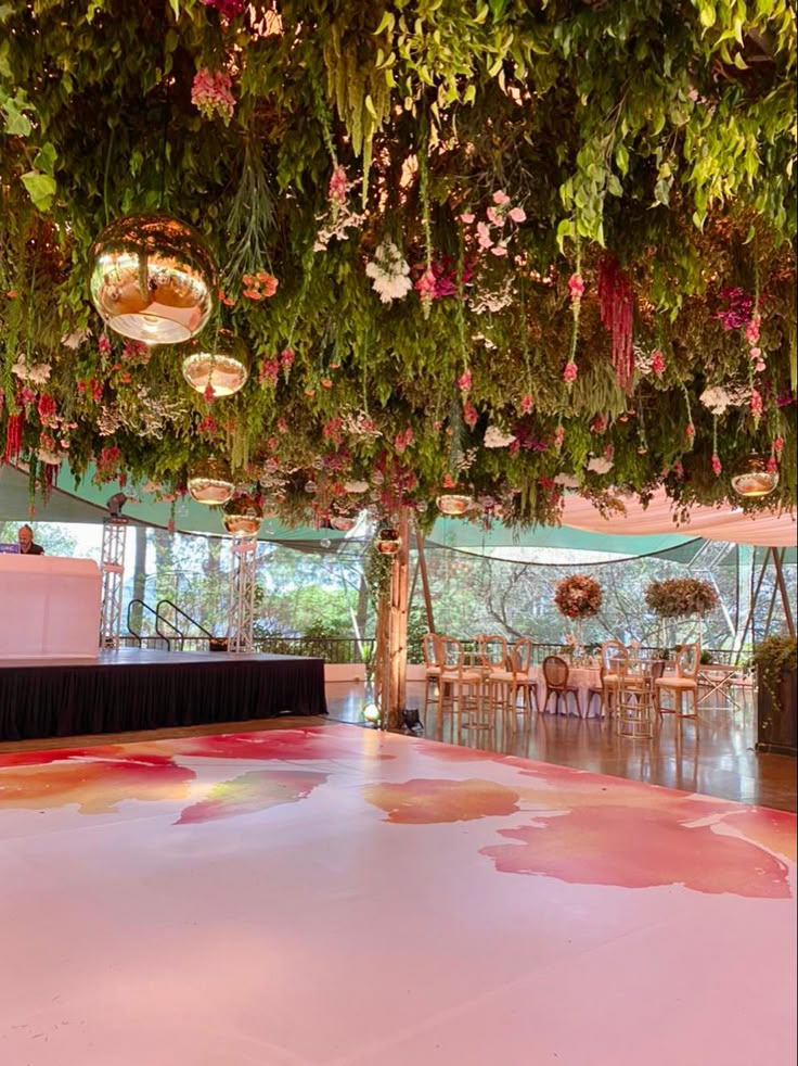 the ceiling is covered with flowers and greenery