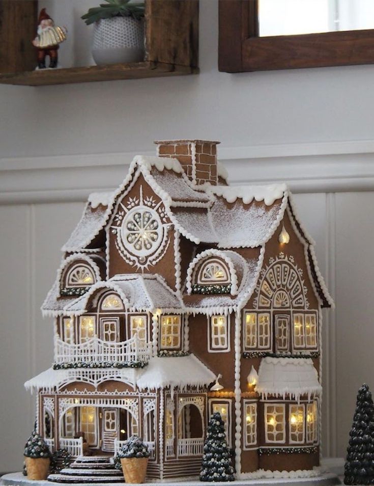 a lighted gingerbread house on a table