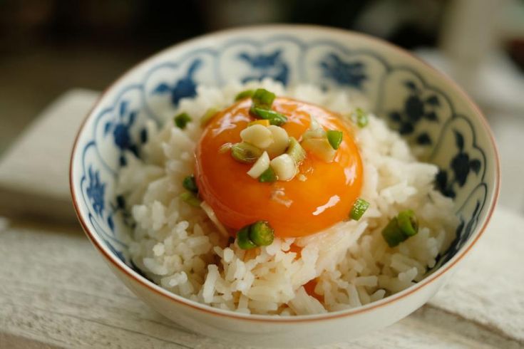 a bowl filled with rice and vegetables on top of a table