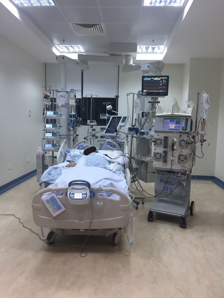 an empty hospital room with medical equipment in it