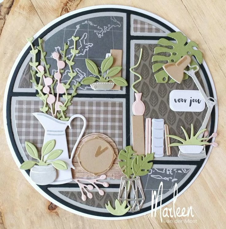 a close up of a paper plate with flowers and plants on the inside of it