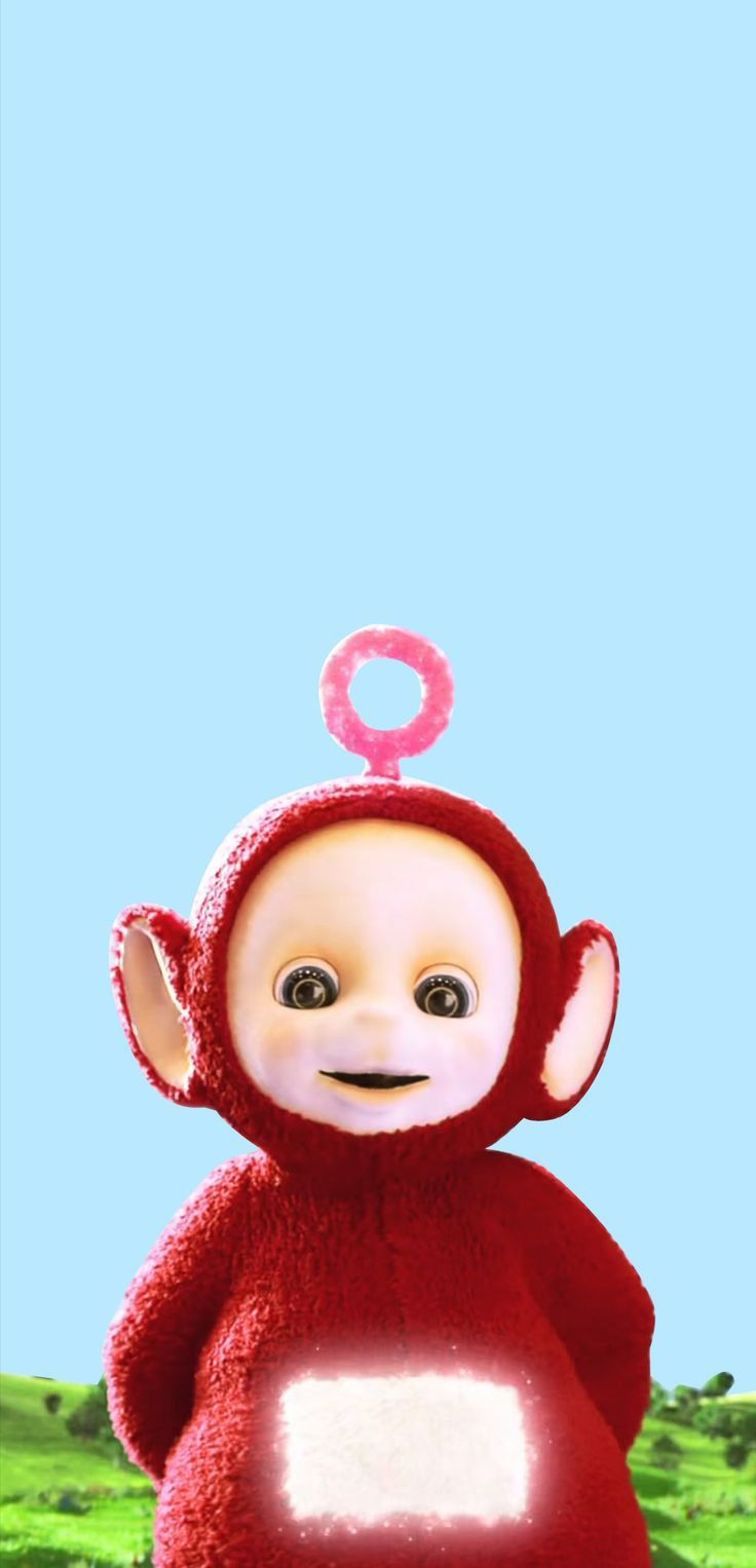 a red monkey with a donut on its head standing in front of a blue sky