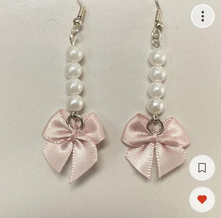 pair of earrings with pink bow and pearls