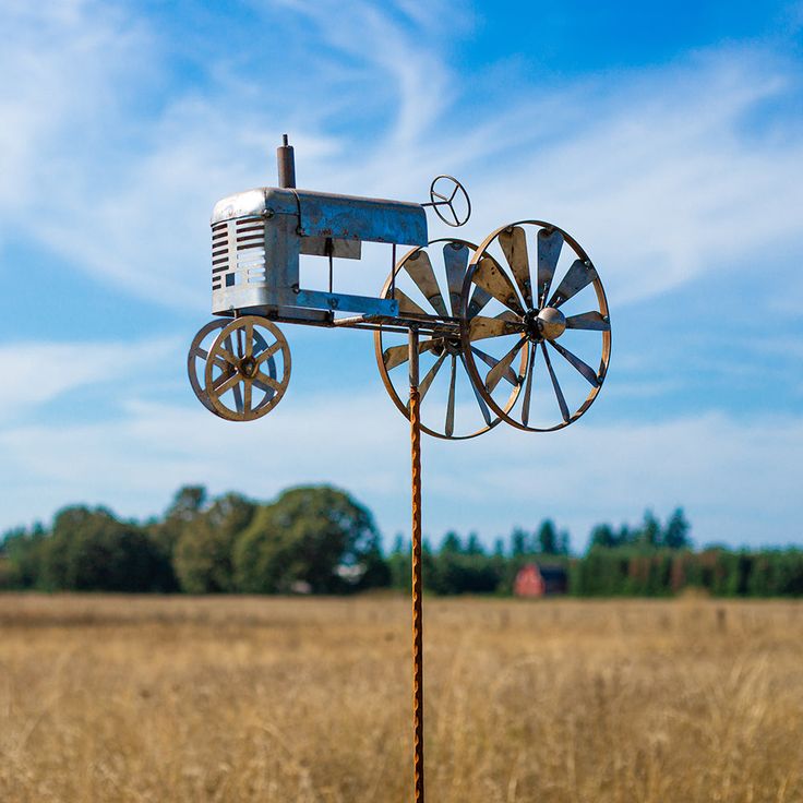 an old fashioned farm windmill in a field