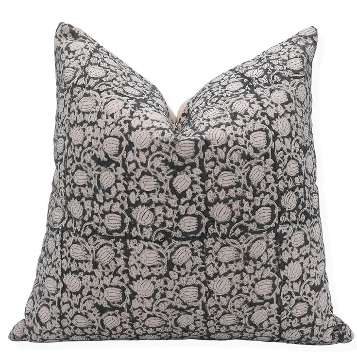 a black and white pillow on a white background