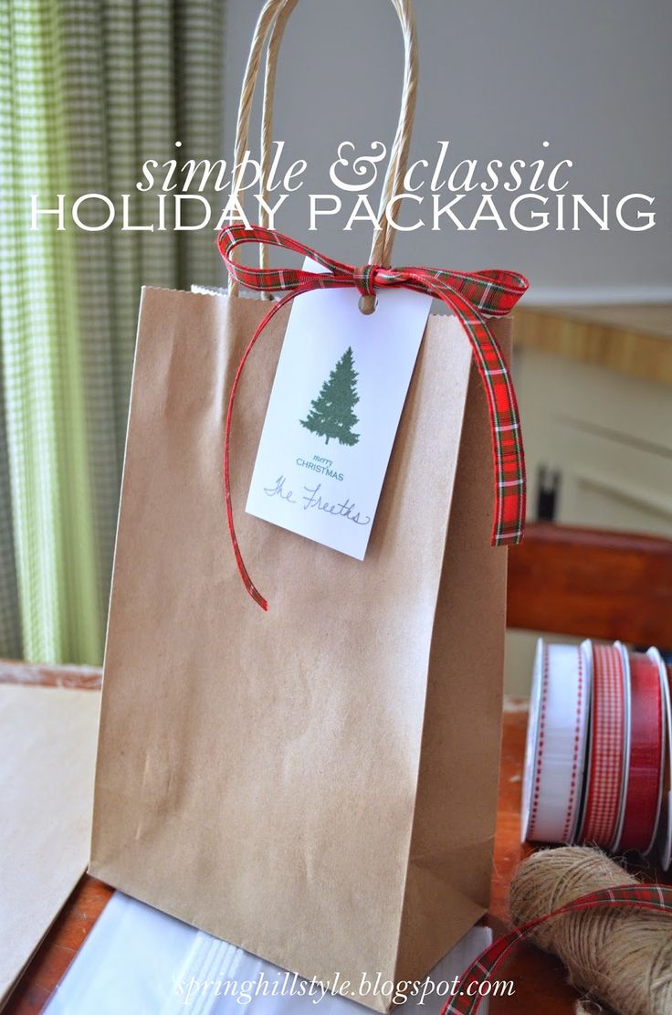 a brown paper bag with a christmas tree tag on it sitting on top of a table