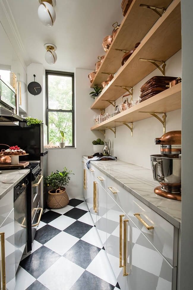 a black and white checkered floor in a kitchen with open shelves on the wall