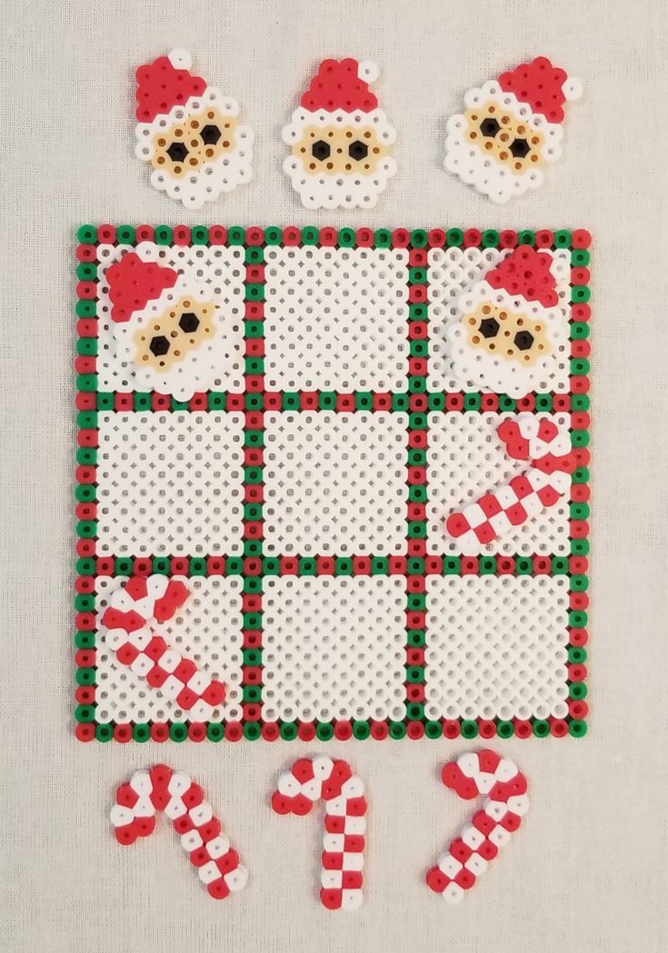 a christmas themed cross stitch pattern with teddy bears and candy canes on the table