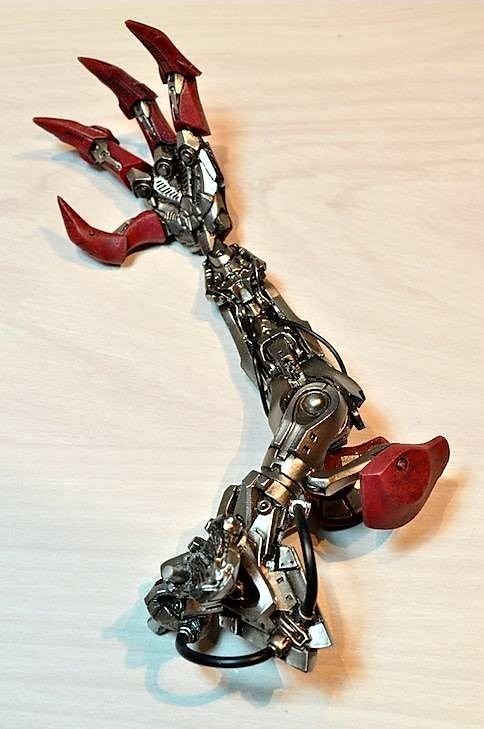 a metal sculpture that looks like it has been made from red and silver parts on it