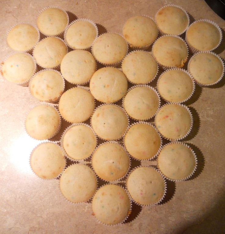 several cupcakes are arranged in the shape of a heart