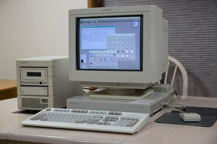 an old computer sitting on top of a desk