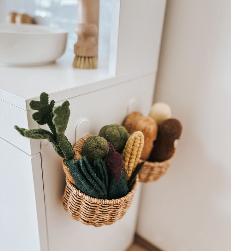 a basket filled with assorted knitted items sitting on top of a white counter