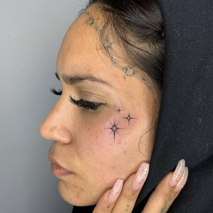 a woman with a star tattoo on her face