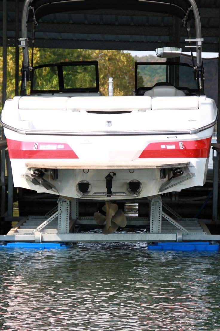 there is a boat sitting on the back of a truck in the middle of water