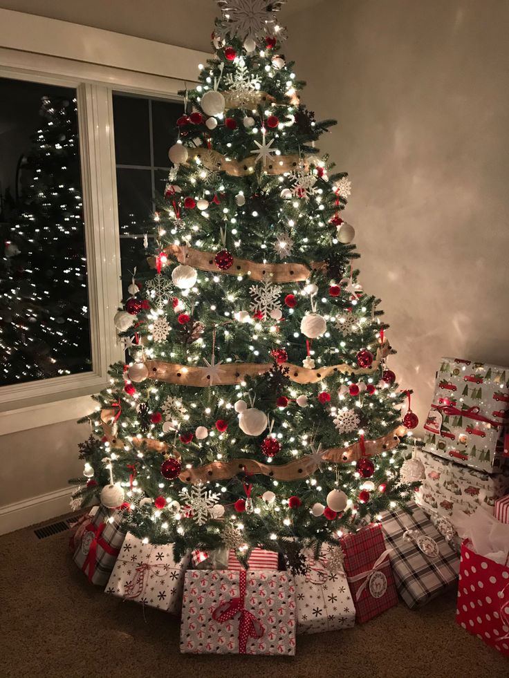 a christmas tree with presents under it