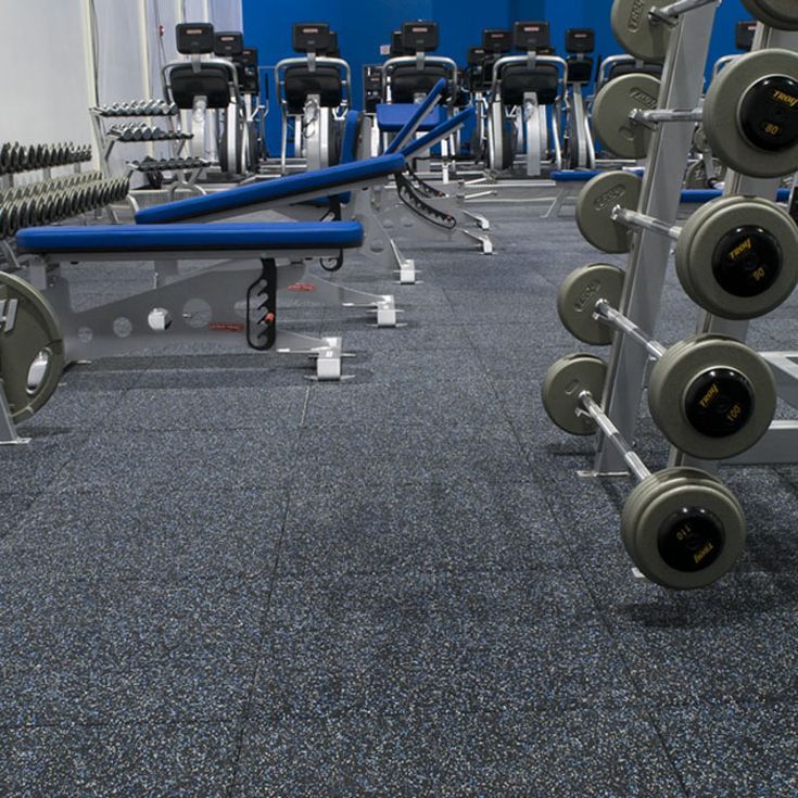 an empty gym with rows of dumbbells