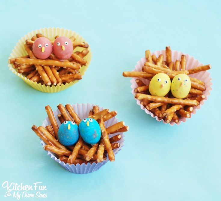 three little birds in nests made out of pretzels with eggs on them