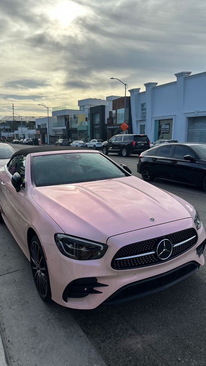 a pink mercedes benz coupe parked in a parking lot