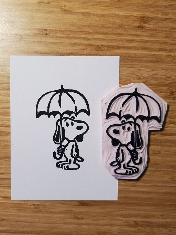 a stamp with a dog holding an umbrella next to a drawing of a man and woman