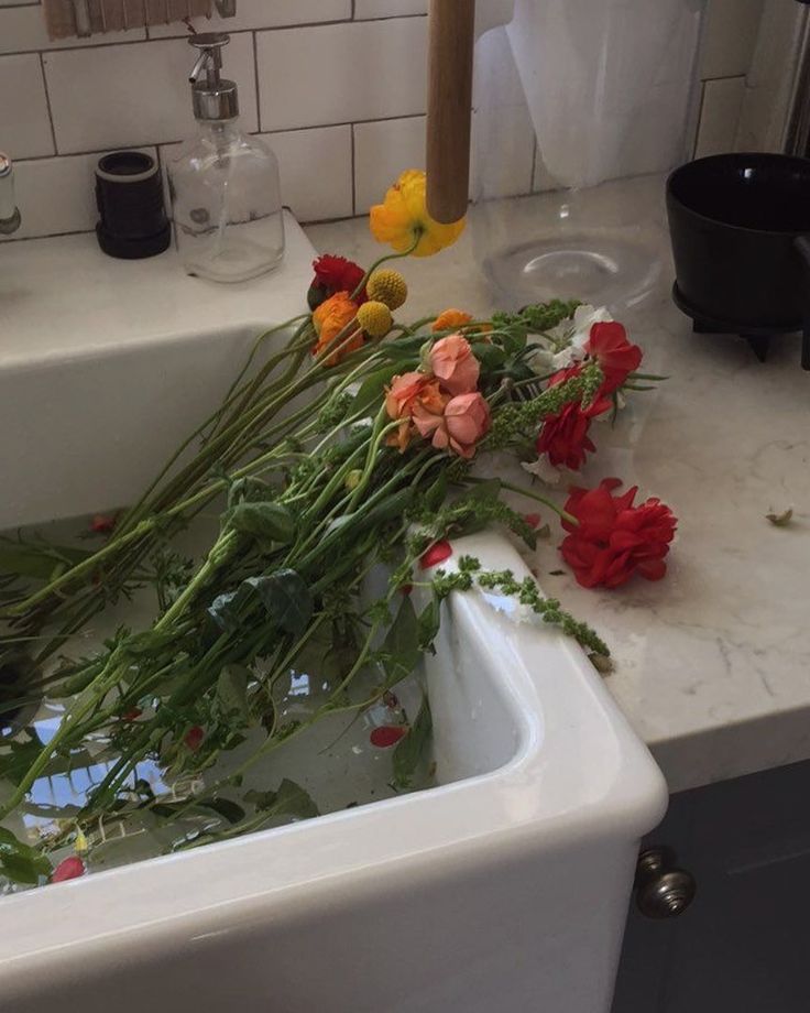 some flowers are sitting in a sink with water