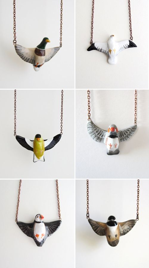 four different pictures of birds hanging from chains on the wall, each with an individual's hand painted bird