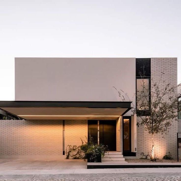 a modern house with white brick and black trim