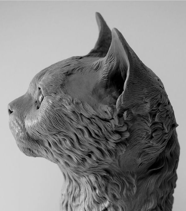 a black and white photo of a statue of a dog's head with its eyes closed