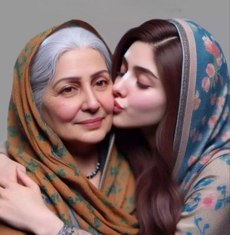 two women are kissing each other while wearing scarves