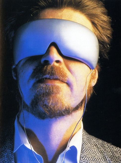 a man wearing a blindfold and headphones